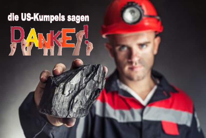Coal miner showing lump of coal against a dark background